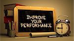 Improve Your Performance Concept Hand Drawn on Chalkboard. Blurred Background. Toned Image.