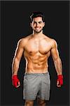 Portrait of a young male Body Combat atlhlete, isolated over a gray background