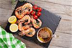 Grilled shrimps on stone plate and beer mug