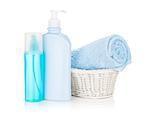 Cosmetics bottles and blue towel. Isolated on white background