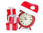 Christmas clock, gift boxes and santa hat. Isolated on white background