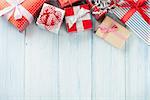 Christmas gift boxes on wooden table with snow. Top view with copy space