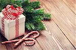 Christmas gift box, candy cane and fir tree branch. View with copy space