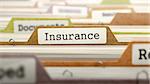 Insurance - Folder Register Name in Directory. Colored, Blurred Image. Closeup View.