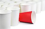 There is one red and many white empty paper cups isolated on white background. The white cups are on the diagonal of the image, the red cup is among them.