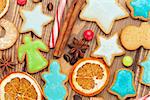 Gingerbread cookies and spices on wooden table