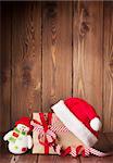 Christmas gift box with santa hat and snowman toy. View with copy space