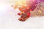 Christmas decorations nestled in snow with retro effect