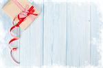 Christmas gift box on wooden background with frozen edges. View with copy space