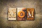 The word "MOM" written in rusty metal letterpress type on an old aged leather background.