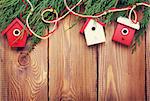 Christmas fir tree and birdhouse decor on rustic wooden board with copy space. Toned