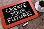 Create Your Future - Inspirational Quote Hand Drawn on Red Chalkboard on Wooden Table. Business Background. Top View.