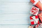 Christmas gift boxes on wooden table with snow. Top view with copy space