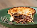 close up of rustic meat and mushroom pie