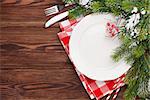 Christmas table setting with fir tree on wooden table. Top view with copy space