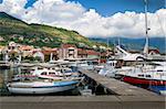 Tivat local fisherman's boats marina. Old traditional boats and contemporary sailing yachts moored at pier. Montenegro