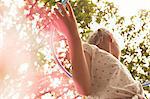 Low angle view of girl playing with hula hoop looking away