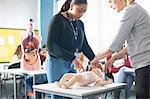 Lecturer giving guidance to college student in Childcare class