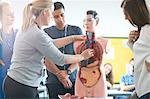 Lecturer speaking to college students in human anatomy class