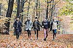 Girls running in autumn forest