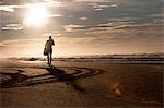 Silhouette of diver on sand, Wild Coast, South Africa