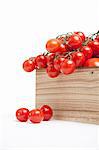 Wood crate filled with fresh vine tomatoes