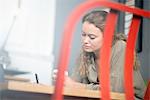 Female print designer working at desk in workshop