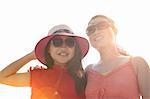 Woman and daughter wearing sunglasses in sunlight