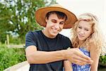 Young couple looking at insect in river rowing boat