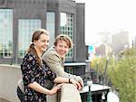 Young couple enjoying view from terrace, Melbourne, Victoria, Australia
