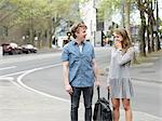 Young couple carrying bag together on street, Melbourne, Victoria, Australia