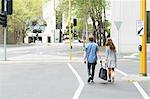 Young couple carrying bag together on street, Melbourne, Victoria, Australia