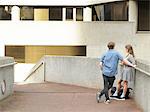 Young couple chatting on walkway, Melbourne, Victoria, Australia