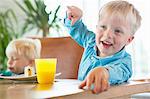 Boy and toddler brother at tea table