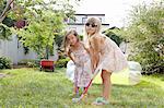 Girls playing kids golf in garden