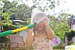 Girl with butterfly net over head in garden