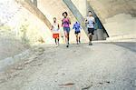 Joggers running on bridge, Arroyo Seco Park, Pasadena, California, USA