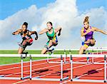 Runners jumping over hurdle on track