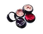 Close-up of Group of Lip Gloss Compacts on White Background