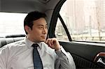 Businessman looking out car window