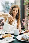 Woman pouring a cup of tea.