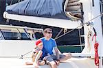 family enjoying summer vacation at sailboat together