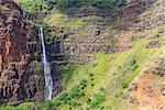 view at remote waterfall at the island of kauai, hawaii from helicopter