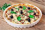 Pizza homemade arugula wooden background olives cheese