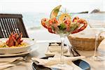 View of a meal in sea shore restaurant with sea in a background.