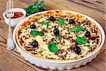 Pizza homemade sauce fork wooden background olives cheese