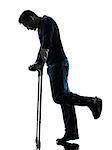 one man injured man walking sad with crutches in silhouette studio on white background