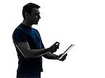 one  man cleaning dusting digital tablet in silhouette on white background
