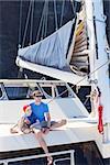 family of two enjoying summer vacation at catamaran boat