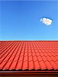 new roof with orange red sheet metal and background of blue sky